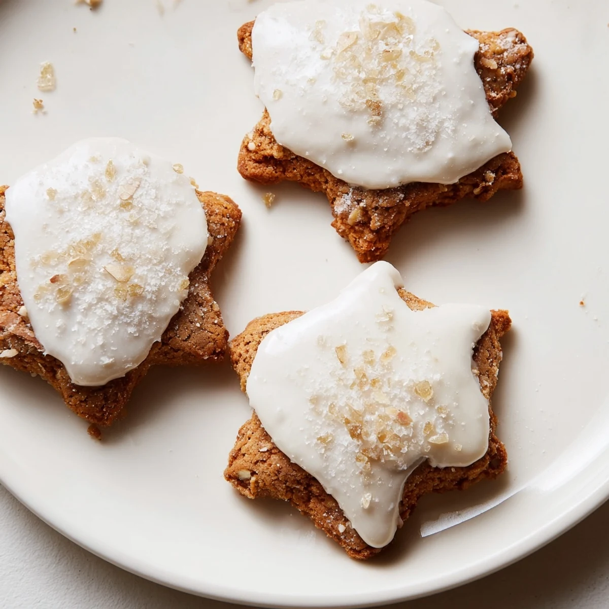 Golden, star-shaped Cinnamon Stars cookies, freshly baked, ready to be enjoyed with a cup of coffee.