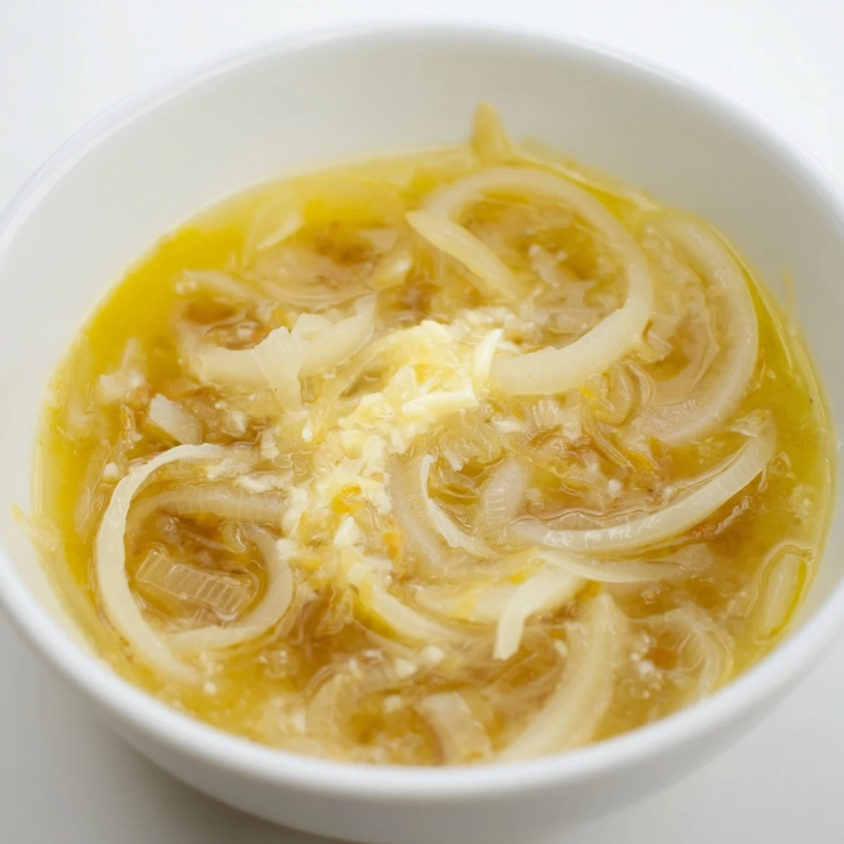 Golden-brown German Cheese and Onion Beer Soup, bubbling with melted cheese and fresh herbs, ready to serve.