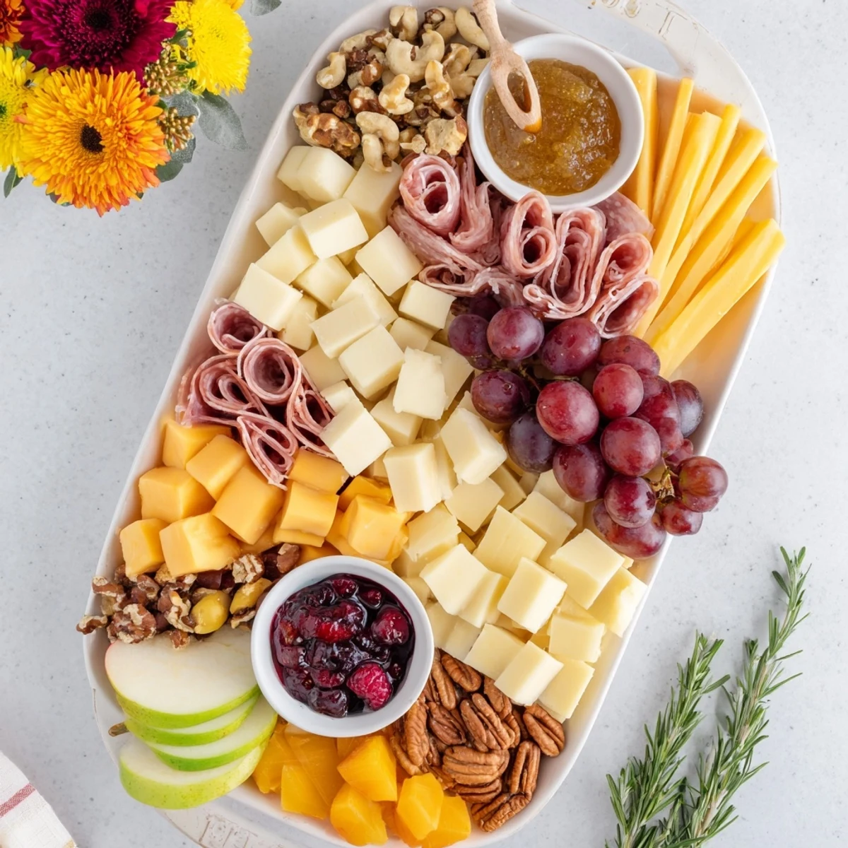 This colorful Maple Leaf Grazing Tray features an array of delicious cheeses, perfect for any gathering.