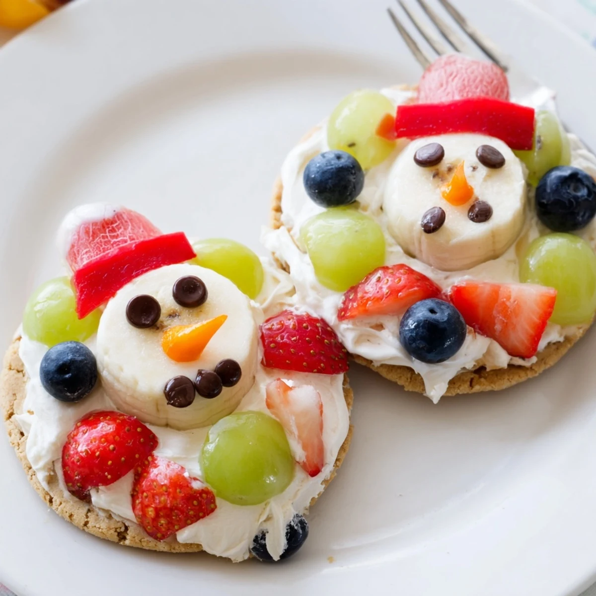 Melting Snowman Fruit Pizza: a colorful dessert pizza featuring melting snowman decorations with fresh fruit.