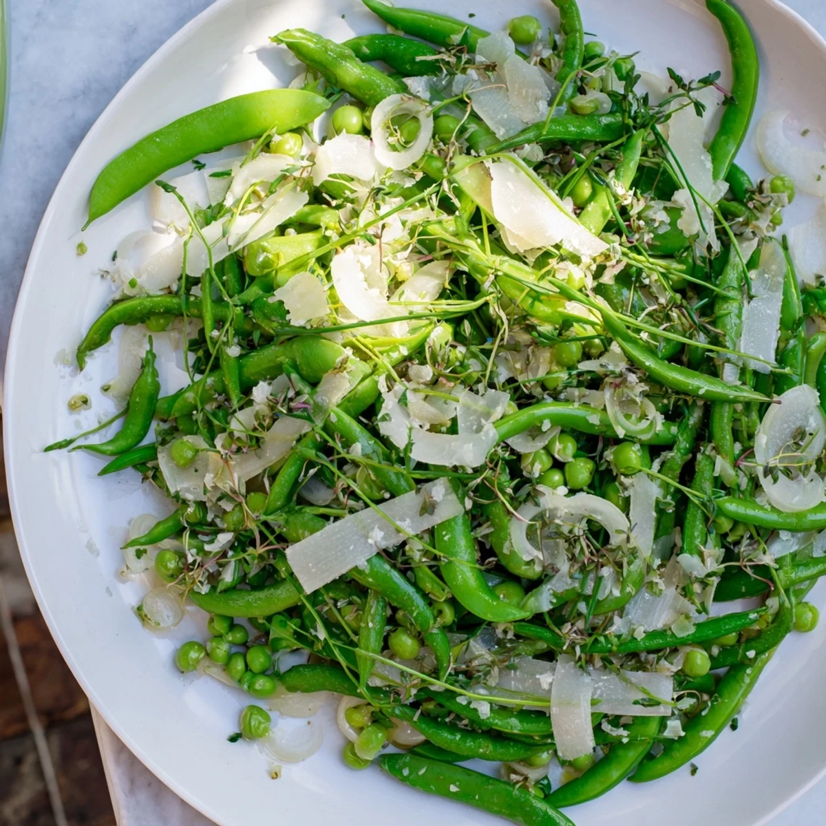 A visually stunning The English Ivy salad, featuring green snap peas and white cheddar, tossed in a light dressing.