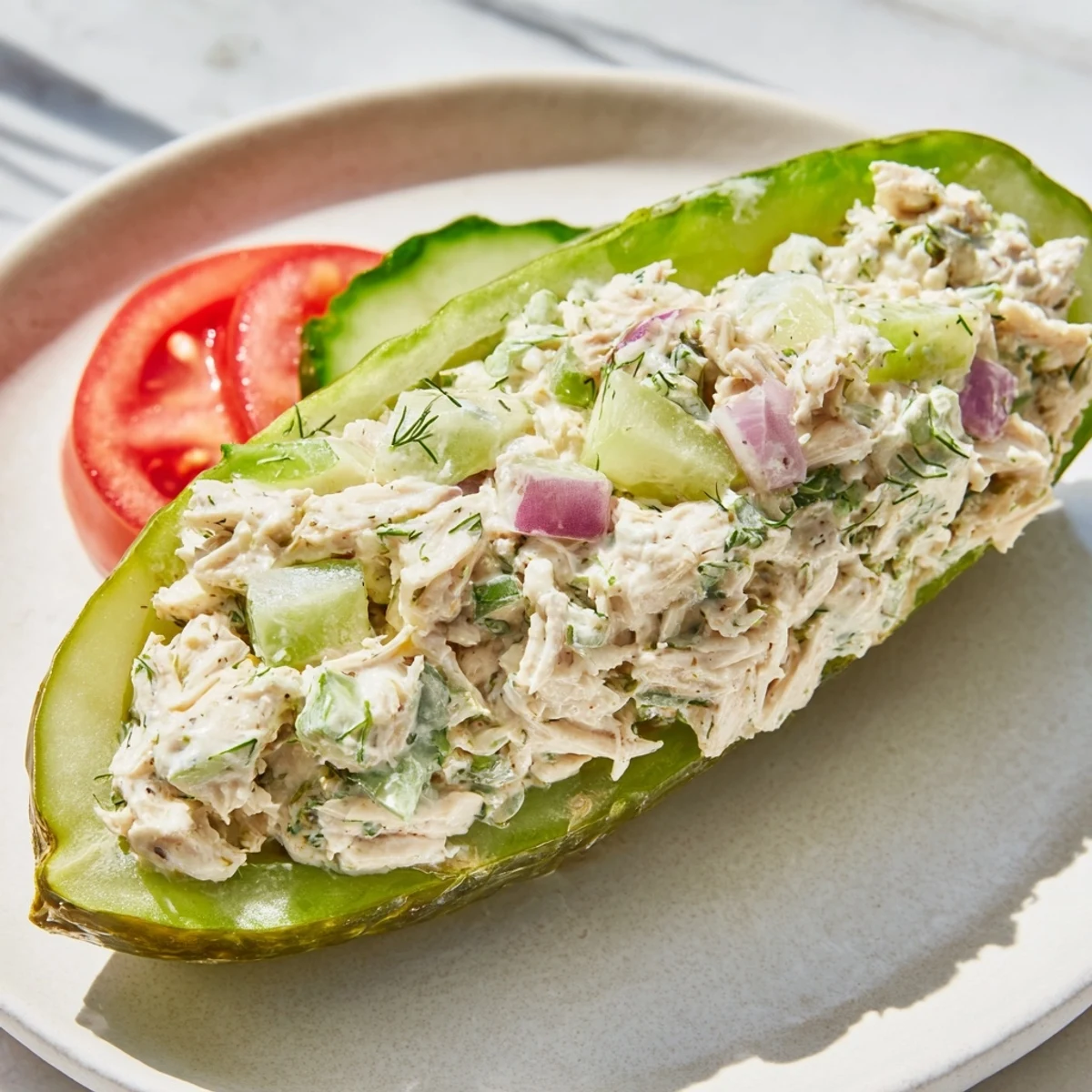 A close-up of a flavorful pickle sandwich with chicken salad, perfect for a refreshing lunch.