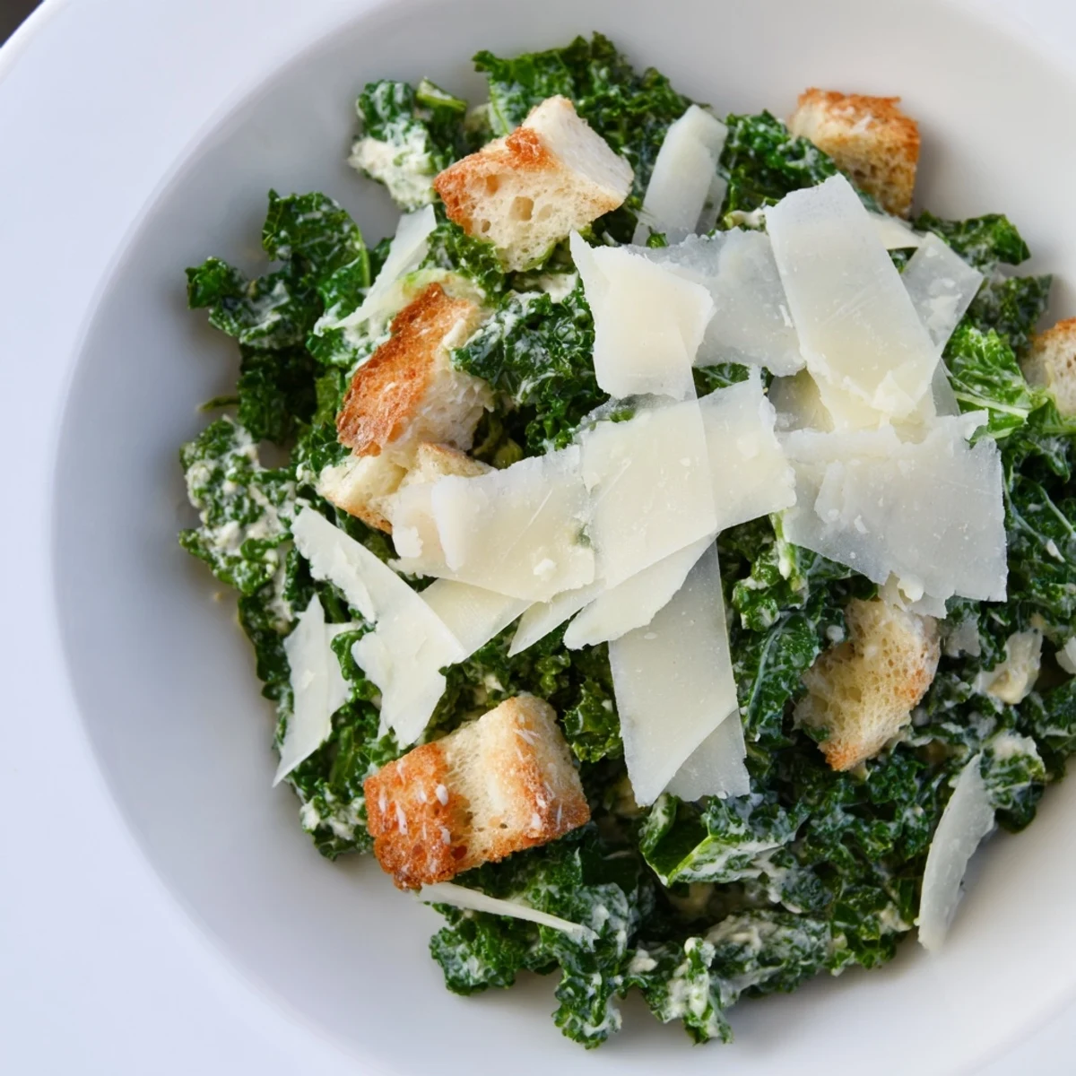 Fresh, homemade Kale Caesar Salad: a bright bowl of massaged kale with creamy dressing.