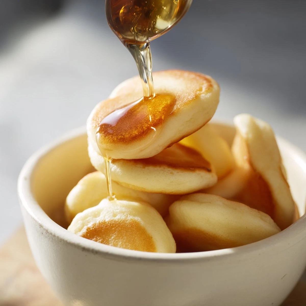Small, delicious bites of fluffy pancake cereal, perfect for a fun breakfast treat.
