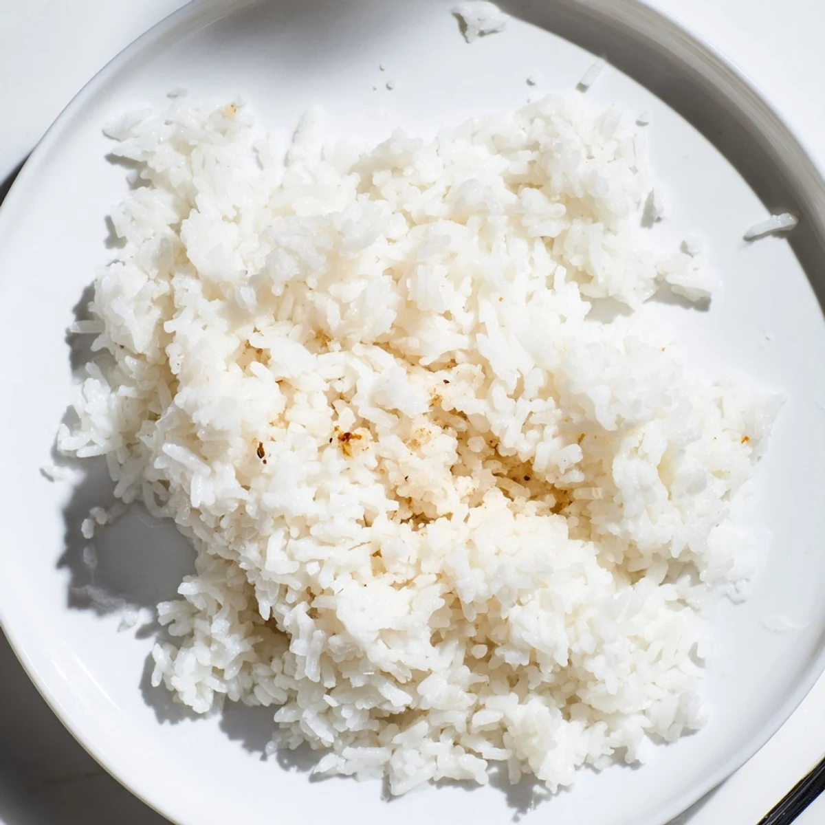 A bowl of warm, cooked coconut jasmine rice, offering a delicate floral aroma and creamy texture.