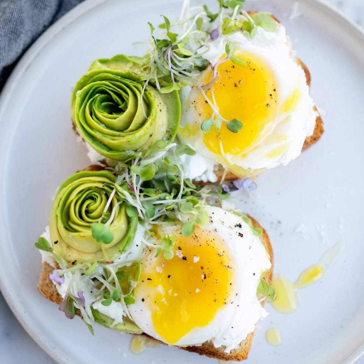 A close-up of delicious Cloud Toast 2.0, showing the soft egg white clouds and fresh microgreens.