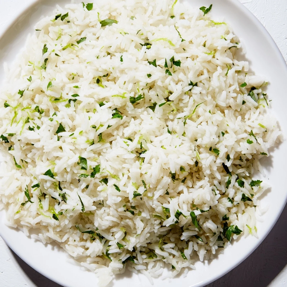 A close-up of cilantro lime rice, showing the fluffy texture and vibrant lime zest.
