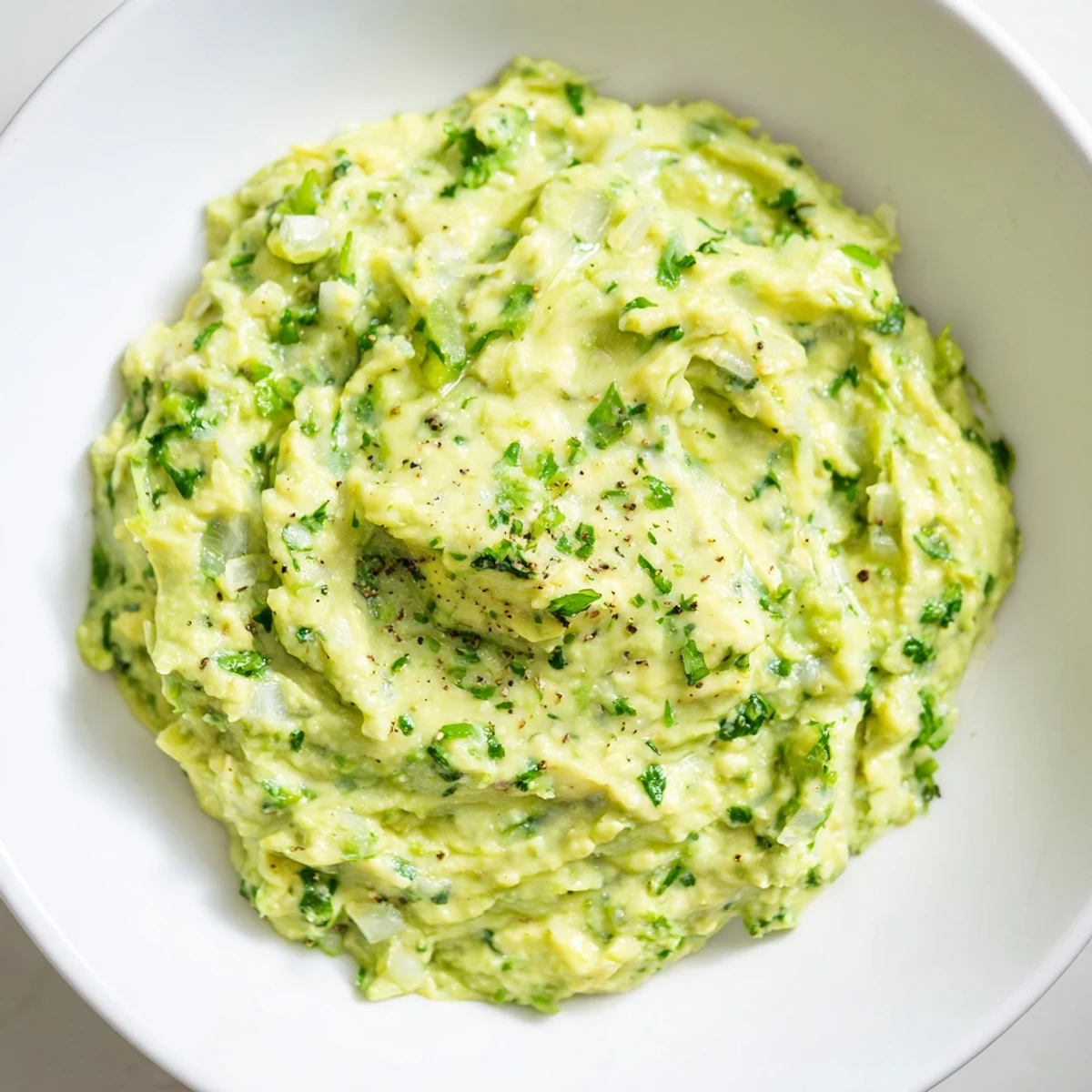 Creamy Avocado Lime Dip, a bright green dip, served with crispy tortilla chips, perfect snack.