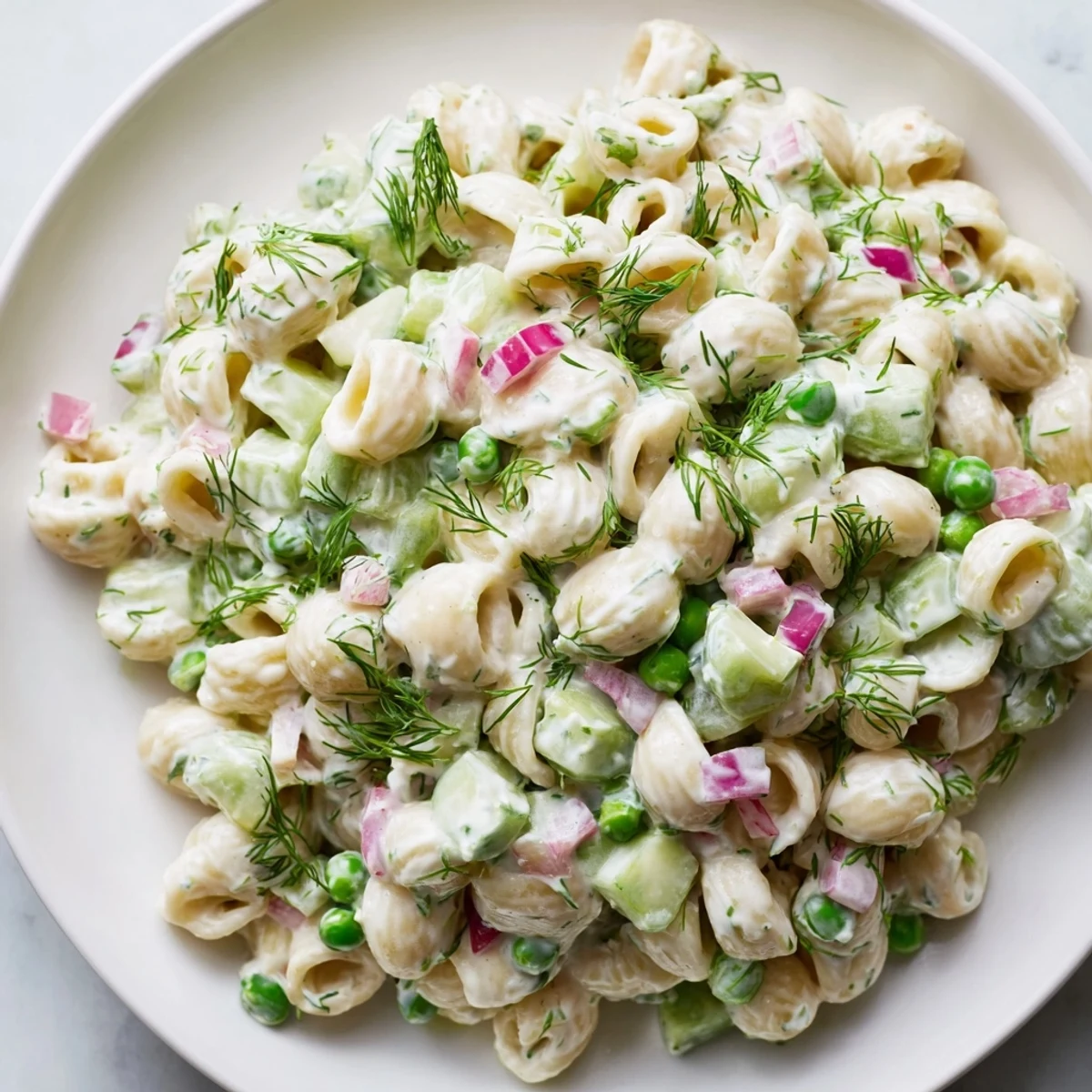Creamy dill pickle pasta salad, a delightful American side dish, chilled and ready to serve.