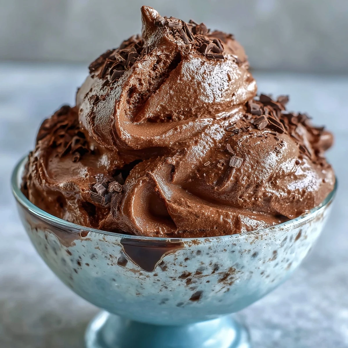 A creamy bowl of chocolate protein fluff, prepared with Greek yogurt and cocoa powder, ready for a post-workout treat.