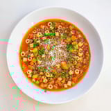 A steaming pot of homemade Ditalini and Lentil Soup, filled with hearty vegetables and lentils.
