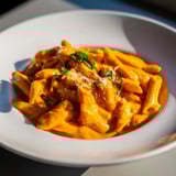 Close-up of Basil Garlic One-Pot Creamy Tomato Pasta, bubbling with a rich, inviting sauce.