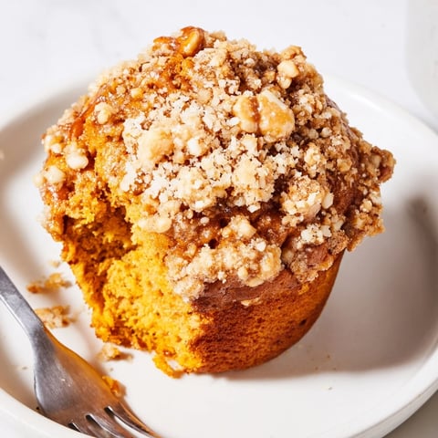 Moist pretzel crumb pumpkin muffins perfect for fall mornings, drizzled with sweetness.  