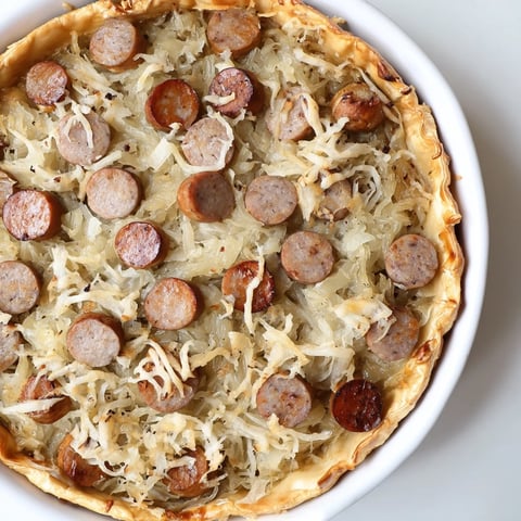 Golden, bubbling Bratwurst & Sauerkraut Pie, showcasing the pretzel crust's buttery crispness and savory filling.