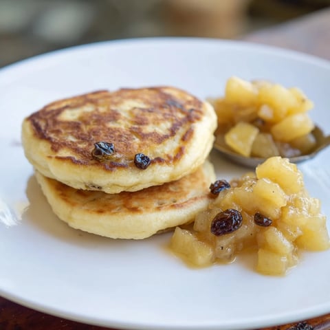 Fluffy, golden brown Quarkkeulchen served with sweet and tangy homemade apple compote for breakfast.