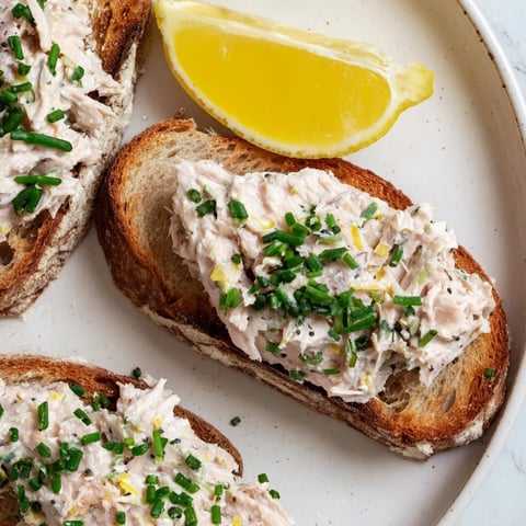 Creamy Carp Pâté Tartine on toasted bread, garnished with fresh herbs, a delightful French appetizer.