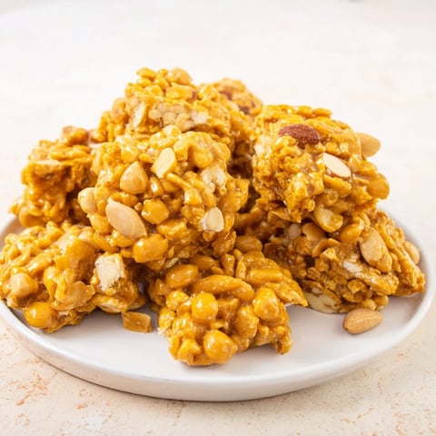 Golden, crunchy budget nut brittle with assorted nuts, glistening, ready for sharing and gifting.