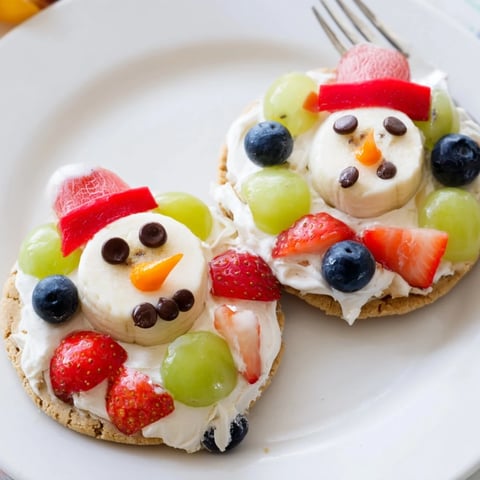 Melting Snowman Fruit Pizza: a colorful dessert pizza featuring melting snowman decorations with fresh fruit.