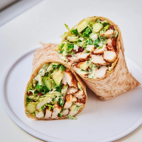 Fresh Green Goddess Chicken Wraps, overflowing with grilled chicken and a vibrant veggie salad for a healthy lunch.