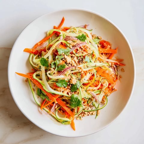 Fresh Thai-Style Peanut Cucumber Salad with vibrant veggies in a creamy peanut dressing.