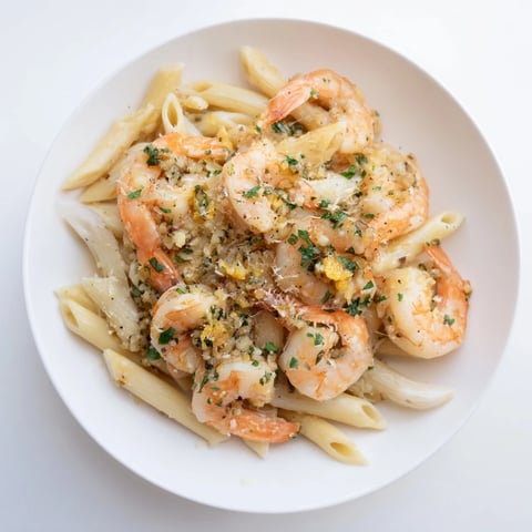 A bowl of Garlic Shrimp Penne, steaming with perfectly cooked shrimp and pasta.