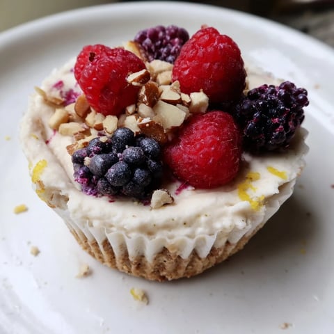 Creamy protein cheesecake cups topped with fresh berries, a healthy and delightful dessert.