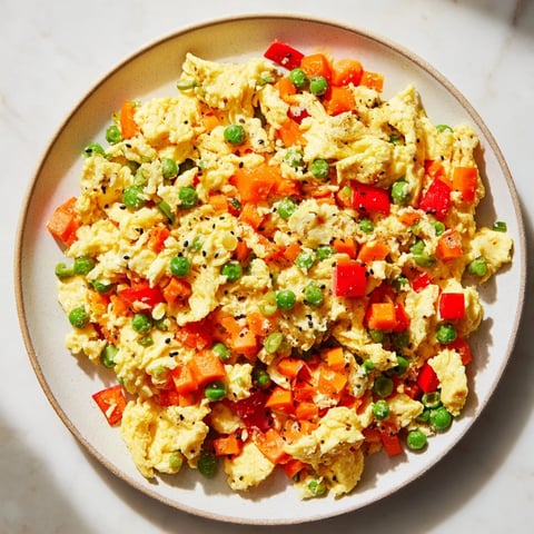 Fluffy egg fried rice with colorful vegetables, a quick and delicious weeknight dinner.