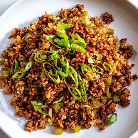 Savory Cajun Dirty Rice topped with a sprinkle of fresh green onions, ready to be enjoyed.