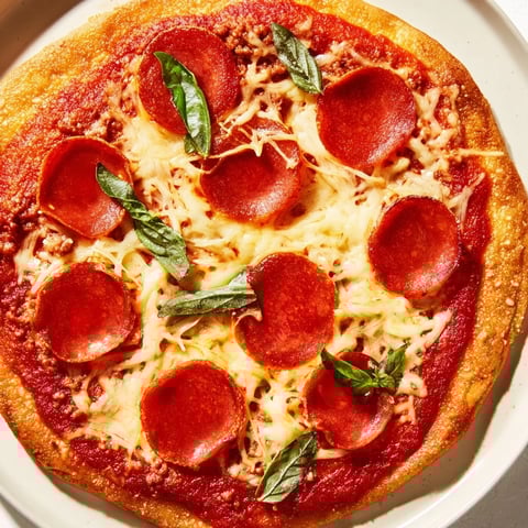 Savory ground beef pizza base topped with melted mozzarella and sizzling pepperoni, ready to enjoy.