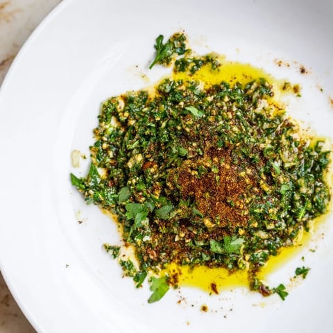 Vibrant bowl of Moroccan Chermoula Marinade, ready to coat fresh fish fillets with flavorful spices.