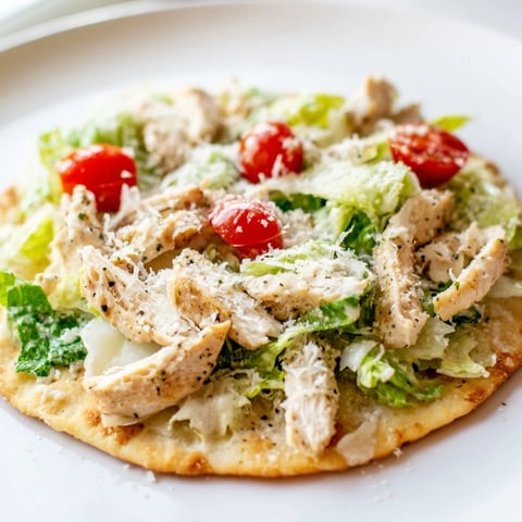 Golden, crispy Chicken Caesar Flatbread, piled high with grilled chicken, fresh romaine and parmesan.