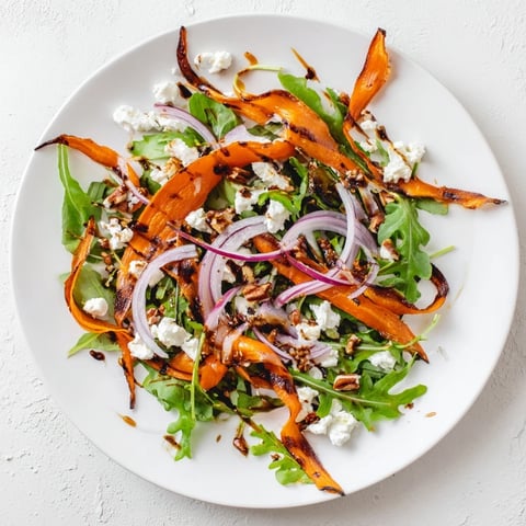 Tender roasted carrot ribbons salad with honey mustard vinaigrette and crumbled feta cheese.