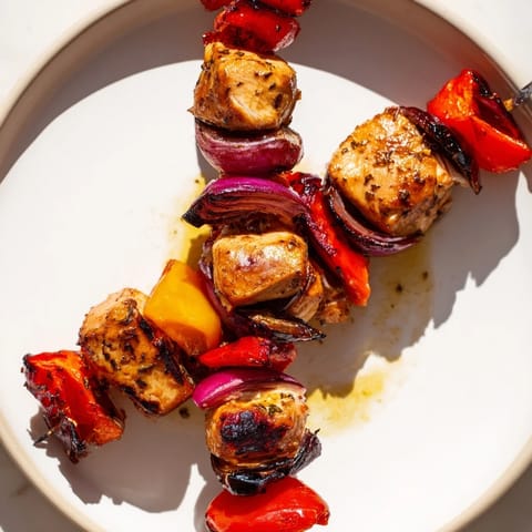 Beautifully charred Glühwein-Marinated Chicken Skewers with colorful bell peppers are an amazing grilling delight.