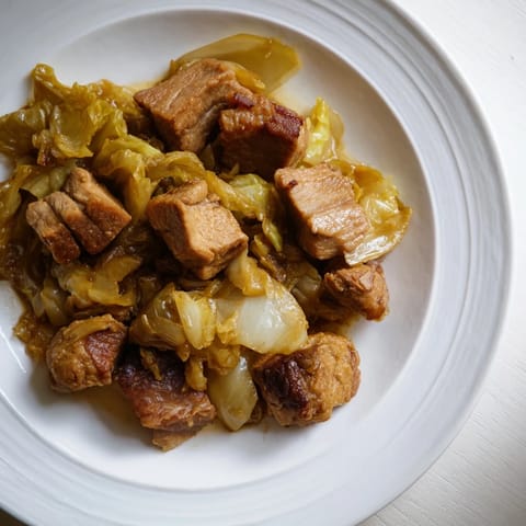 Warm, flavorful Sweet Cabbage and Pork Stew, served with crusty bread, ready to enjoy.