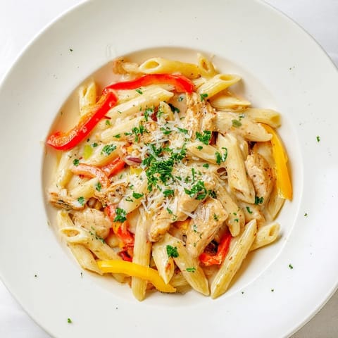Sizzling Cajun Chicken Pasta with vibrant bell peppers in a rich, creamy sauce, for a flavorful dinner.