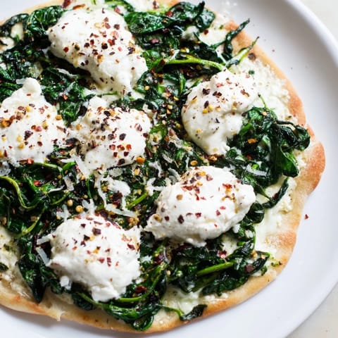 Freshly baked Spinach Ricotta Pizza, with creamy ricotta cheese, ready for a delicious vegetarian meal.