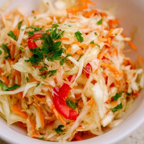 Colorful Sauerkraut Slaw served in a bowl, garnished with fresh parsley, perfect for summer picnics.