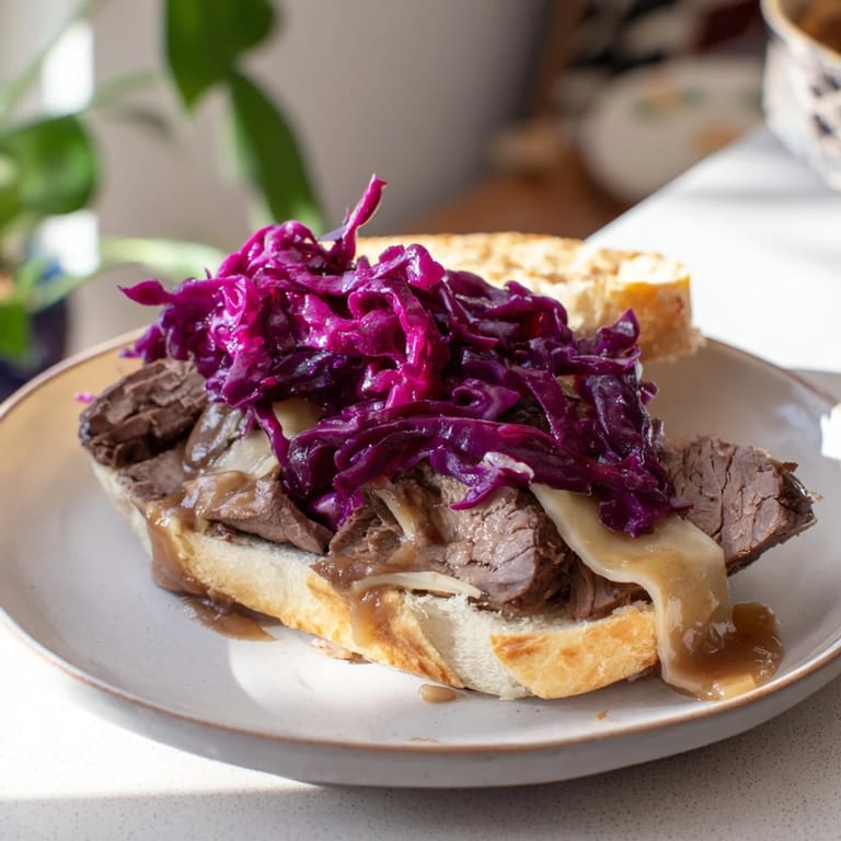 Close-up of juicy Sauerbraten sliders piled high, showcasing the tender beef and flavorful braising juices.