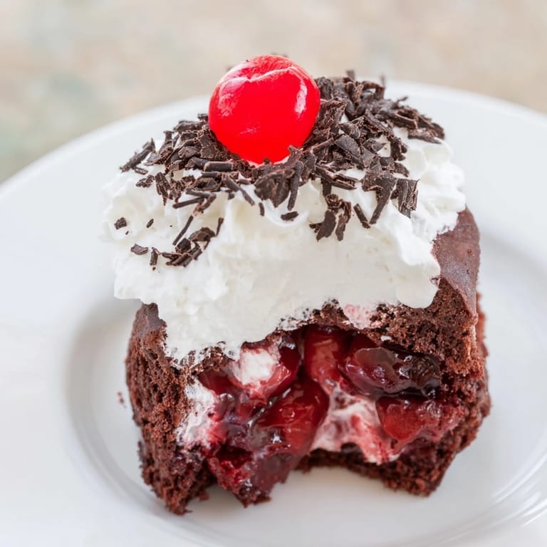 Freshly baked Black Forest cake bites drizzled with shaved chocolate, perfect for a delightful dessert.