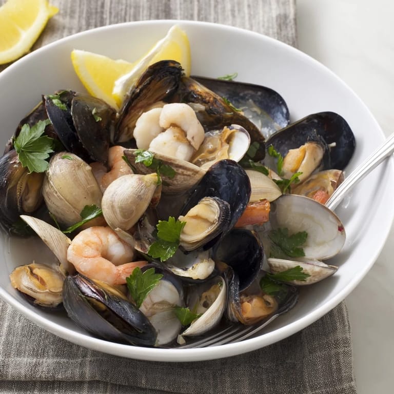 Freshly cooked Shellfish & Seafood Medley steaming, perfect for a pescatarian dinner, ready to serve.