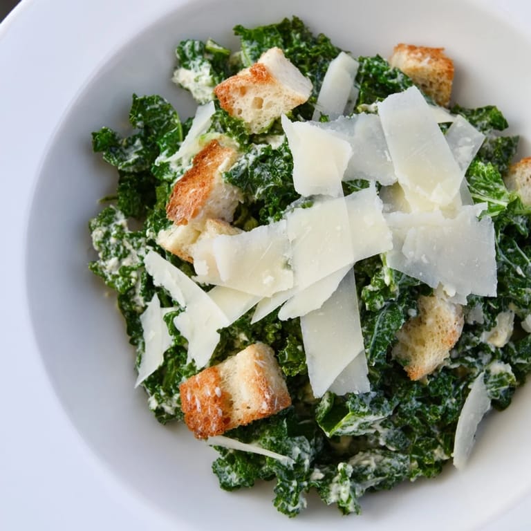 Fresh, homemade Kale Caesar Salad: a bright bowl of massaged kale with creamy dressing.
