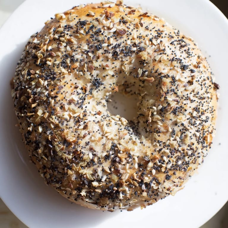 Freshly baked Everything Bagel Yogurt Bagels, with a perfectly chewy texture, served with cream cheese.