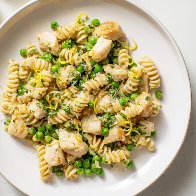 Italian-inspired Garlic Butter Chicken & Pea Pasta, featuring tender chicken, peas, and flavorful sauce.